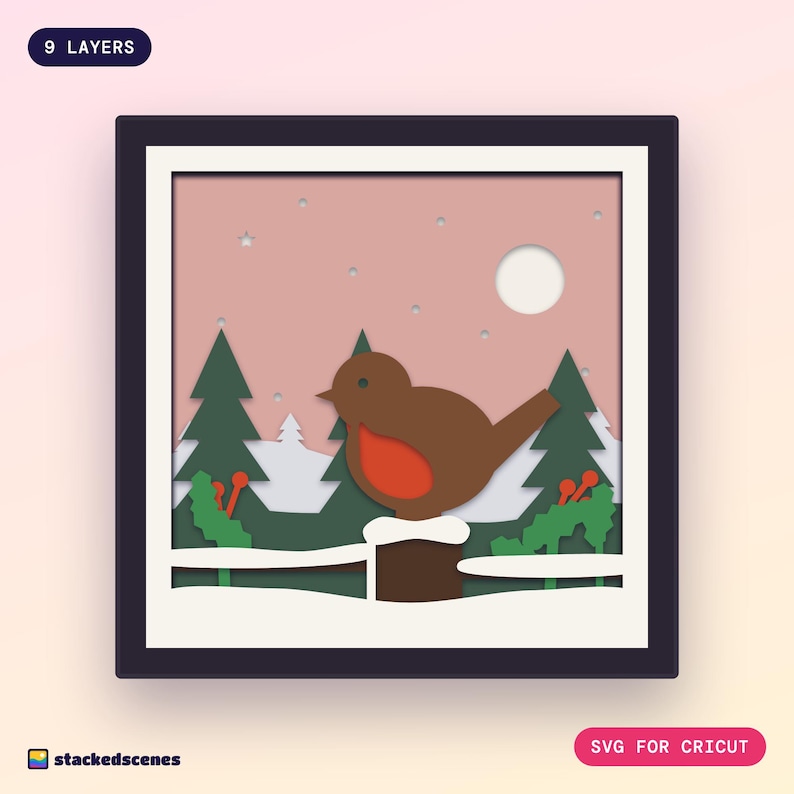 Finished 9-layer robin paper shadow box in a dark frame: a round robin on a snowy fence post with holly, spruces and a pale sun in a rosy sky.