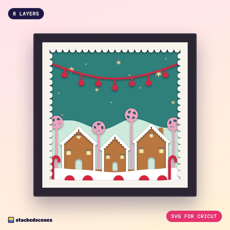 Finished 8-layer paper shadow box of three gingerbread houses with white iced roofs, pink lollipop trees, candy canes and a red sweetie garland.