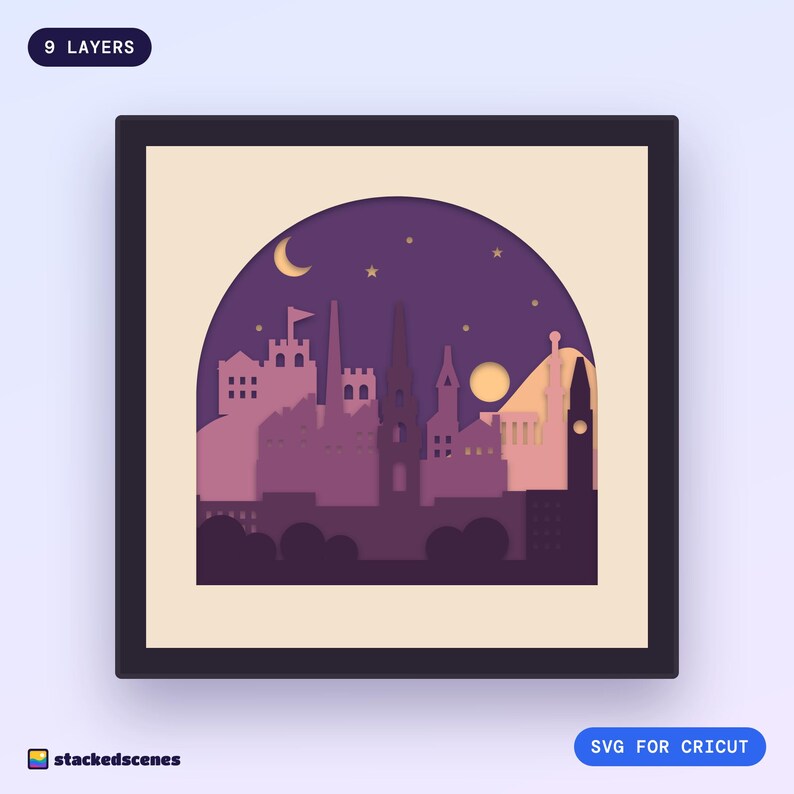 Finished 9-layer paper shadow box of the Edinburgh skyline at dusk in an arched cream frame: castle, spires, Scott Monument and Calton Hill.