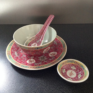 May include: A set of three red and white porcelain bowls with a traditional Chinese design. The bowls feature a repeating pattern of flowers, swirls, and the Chinese character for "happiness".