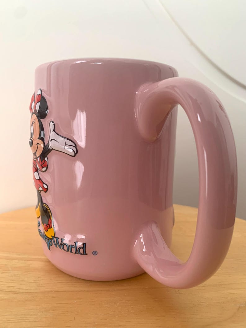 May include: A set of three ceramic mugs with a speckled, matte finish. The mugs are in shades of cream, light grey, and dark grey. Each mug has a simple, modern design and a rounded handle. Ideal for tea or coffee.