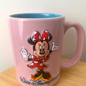 May include: A set of three ceramic mugs with a speckled, matte finish in cream, light grey, and dark grey. Each mug has a simple, minimalist design and a rounded handle.