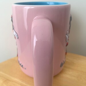 May include: A set of three ceramic mugs with a speckled, matte finish. The mugs are in shades of cream, light grey, and dark grey. Each mug has a simple, minimalist design, ideal for coffee or tea.