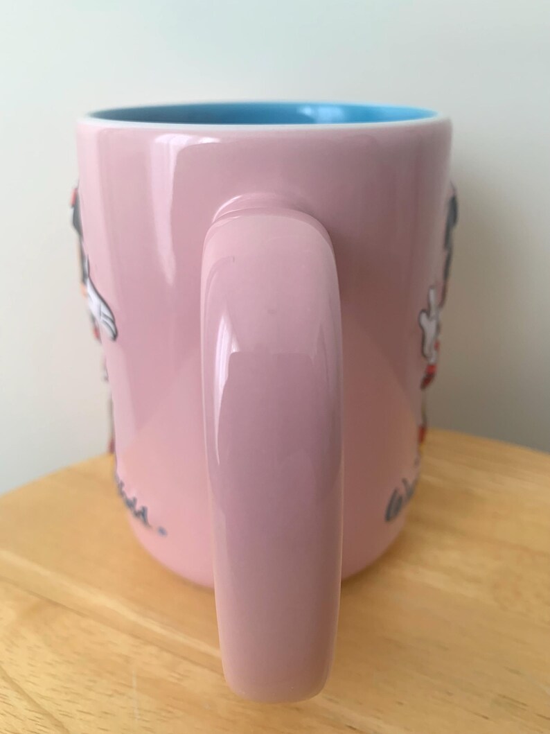 May include: A set of three ceramic mugs with a speckled, matte finish. The mugs are in shades of cream, light grey, and dark grey. Each mug has a simple, minimalist design, ideal for coffee or tea.