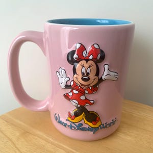 May include: A set of three ceramic mugs with a speckled, matte finish. Each mug is a different colour: light blue, cream, and grey. The mugs have a simple, modern design and a comfortable handle.