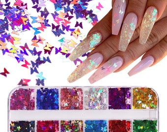 May include: A set of 12 small jars filled with iridescent butterfly-shaped glitter. The glitter is in various colors, including pink, blue, green, and purple. The jars are arranged in a clear plastic case.