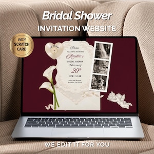 May include: A laptop screen displays a digital bridal shower invitation on a dark red background. The design features a cream-colored lace frame, white calla lilies, a heart-shaped scratch card icon, a photo strip, and a cherub graphic.