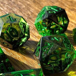 Handmade resin dice, green with black smoke and gold numbers, these are one of our most popular gifts.