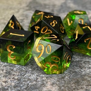 Handmade resin dice, green with black smoke and gold numbers, these are one of our most popular gifts.