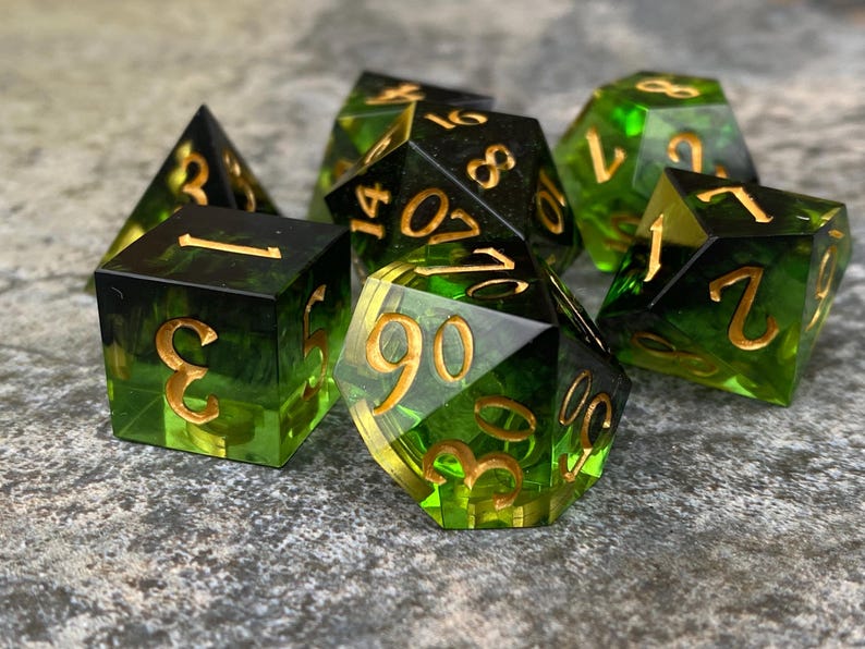 Handmade resin dice, green with black smoke and gold numbers, these are one of our most popular gifts.