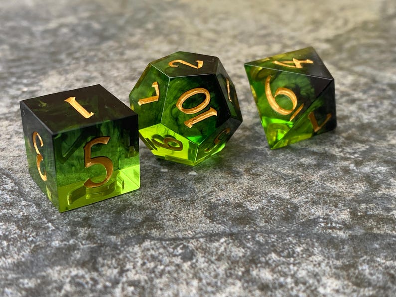 Handmade resin dice, green with black smoke and gold numbers, these are one of our most popular gifts.