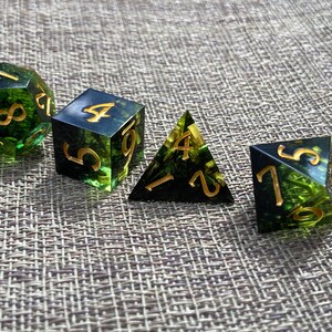 Handmade resin dice, green with black smoke and gold numbers, these are one of our most popular gifts.