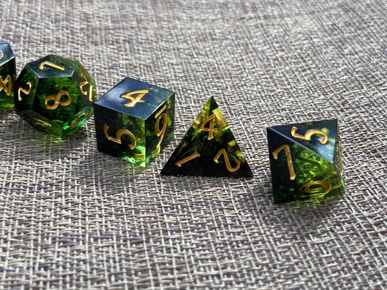 Handmade resin dice, green with black smoke and gold numbers, these are one of our most popular gifts.