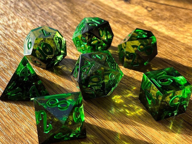 Handmade resin dice, green with black smoke and gold numbers, these are one of our most popular gifts.