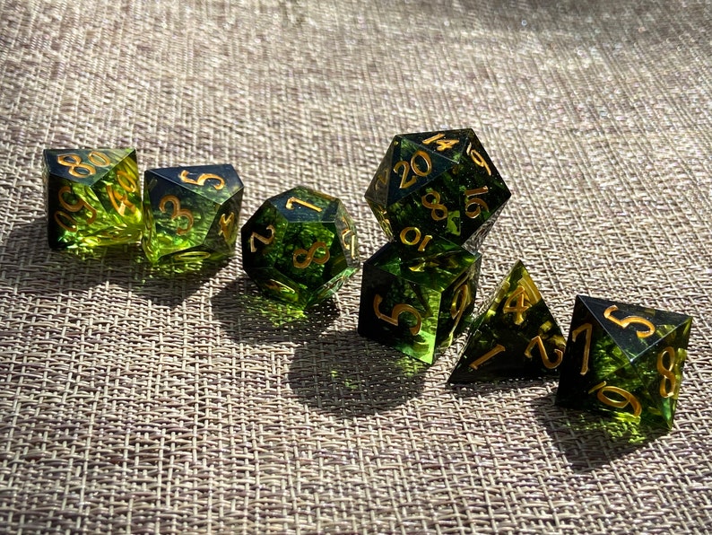 Handmade resin dice, green with black smoke and gold numbers, these are one of our most popular gifts.