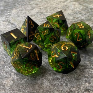 Handmade resin dice, green with black smoke and gold numbers, these are one of our most popular gifts.