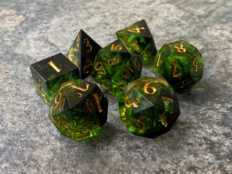 Handmade resin dice, green with black smoke and gold numbers, these are one of our most popular gifts.