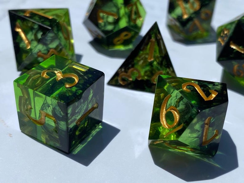 Handmade resin dice, green with black smoke and gold numbers, these are one of our most popular gifts.