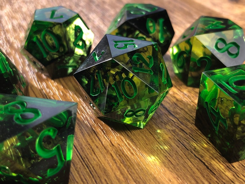 Handmade resin dice, green with black smoke and gold numbers, these are one of our most popular gifts.