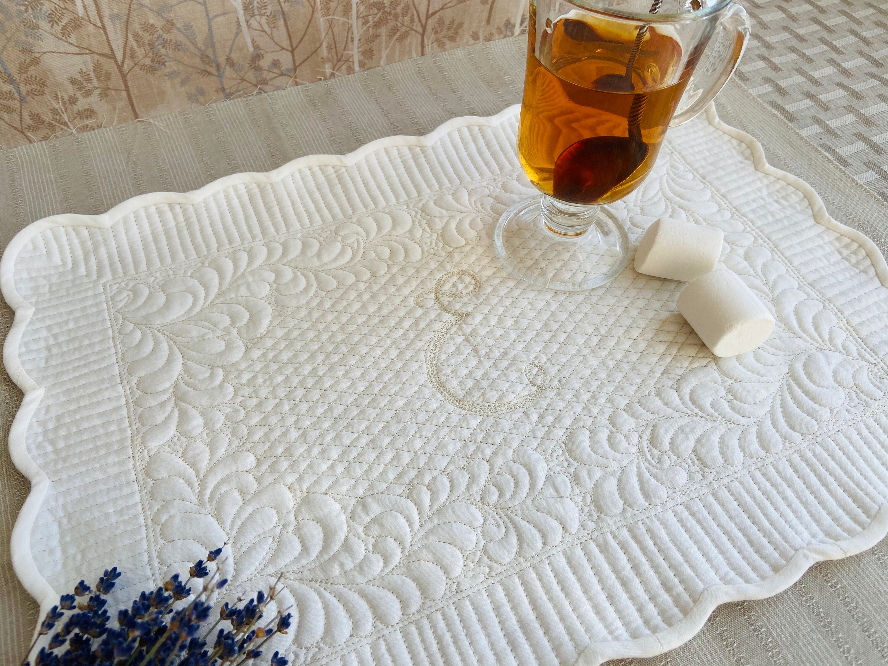Monogrammed ivory quilted placemat on the bedside table or Etsy