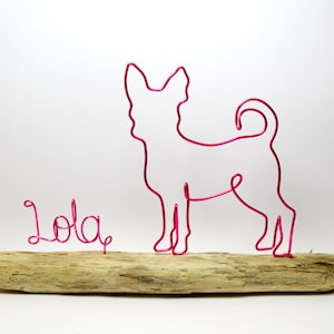 May include: Pink wire sculpture of a chihuahua dog with the name "Lola" written in pink wire on a driftwood base.