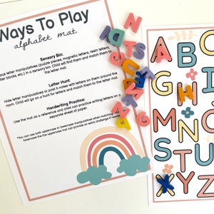 May include: A printable alphabet mat with a rainbow design and instructions for different ways to play with letter manipulatives. The text on the mat reads "Ways To Play alphabet mat".