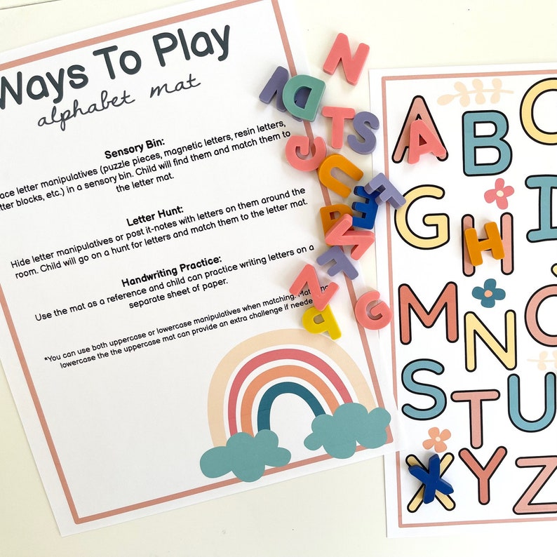 May include: A printable alphabet mat with a rainbow design and instructions for different ways to play with letter manipulatives. The text on the mat reads "Ways To Play alphabet mat".