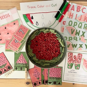 May include: A set of educational activities for kids featuring a watermelon theme. The set includes a counting activity, a tracing and coloring activity, an alphabet activity, and a shape matching activity. The activities are designed to help children learn about numbers, letters, shapes, and colors.