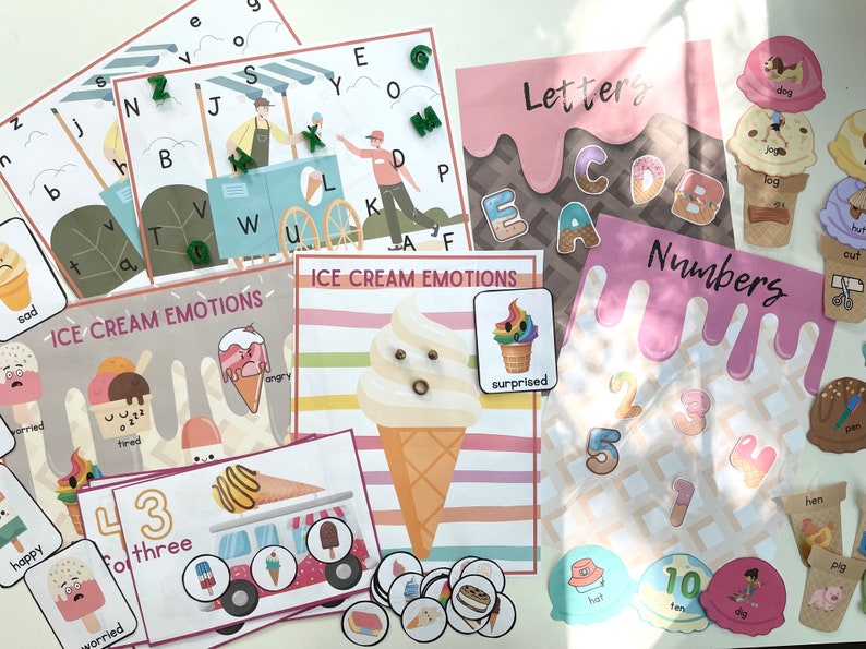 May include: A set of printable educational flashcards featuring ice cream cones with different emotions, letters, and numbers. The flashcards are colorful and feature a variety of ice cream flavors and toppings.