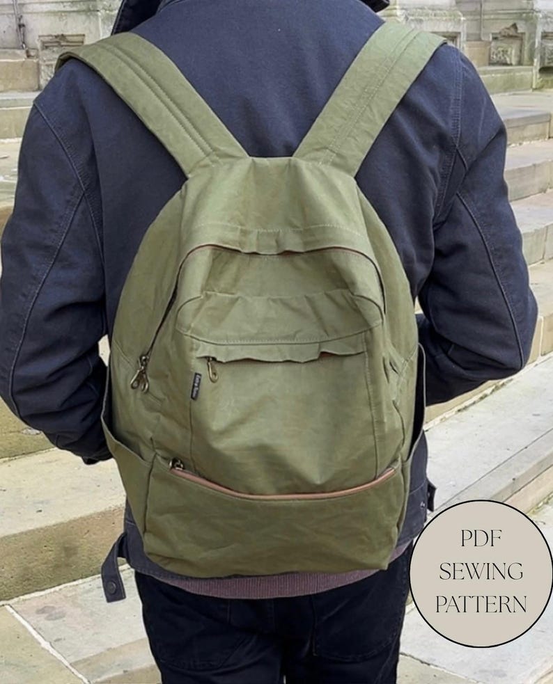 May include: An olive green backpack with multiple pockets and adjustable straps. The backpack has a rectangular shape with a front flap pocket and side pockets. The bag is made of a durable, water-resistant material. The image also includes the text "PDF SEWING PATTERN".