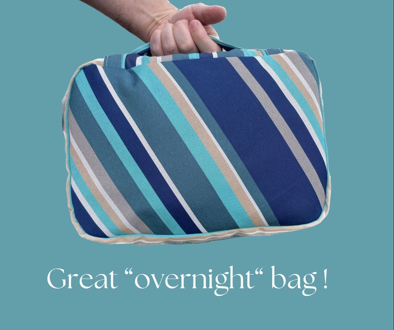 May include: A striped overnight bag with blue, teal, beige, and white stripes. The bag has a zipper closure and a handle.