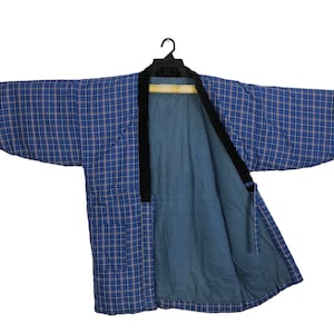 May include: A blue and white plaid kimono with a black sash. The kimono is open in the front, revealing a solid blue lining.