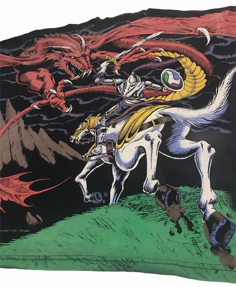 May include: An illustration of a knight on a white horse battling a red dragon. The knight is clad in silver armor and wields a sword. The dragon has large wings and sharp claws. The background is dark with a green grassy area.