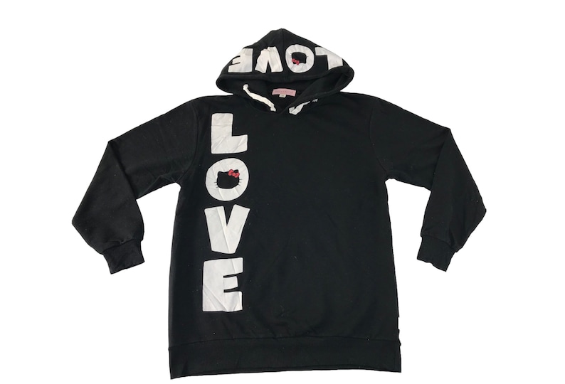 May include: Black hooded sweatshirt with the word "LOVE" in large white letters down the front. The hood features the word "LOVE" in white. A small Hello Kitty graphic is incorporated into the "O" in "LOVE".