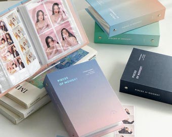 May include: A set of three photo albums with a gradient color design. The albums are blue, green, and pink. The albums have the text "Pieces of Moment" printed on the front.