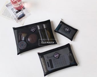 May include: Three black mesh pouches with zipper closures. The pouches are labeled 01, 02, and 03. The pouches are filled with various items, including a bottle of spray, a calculator, and makeup.