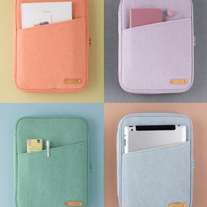 May include: Four zippered tablet cases in different colors: peach, lavender, light green, and light blue. Each case has a zipper closure and a large pocket on the front. The cases are shown with different items inside, such as a notebook, a tablet, and a pen.