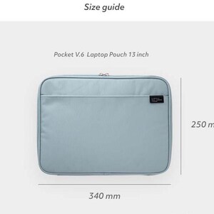 May include: A light blue laptop pouch with a zipper closure. The pouch measures 340 mm wide and 250 mm tall. Pocket V.6 Laptop Pouch 13 inch.