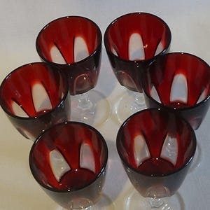 Beautiful selection of Vintage glasses. Sherry glasses, wine glasses, souvenir shot glasses  and minature brass goblets. Priced per set.