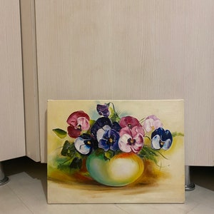 May include: A painting of a bouquet of purple, pink, and white pansies in a green vase. The pansies are arranged in a loose, natural style, and the vase is simple and elegant. The background is a soft yellow.