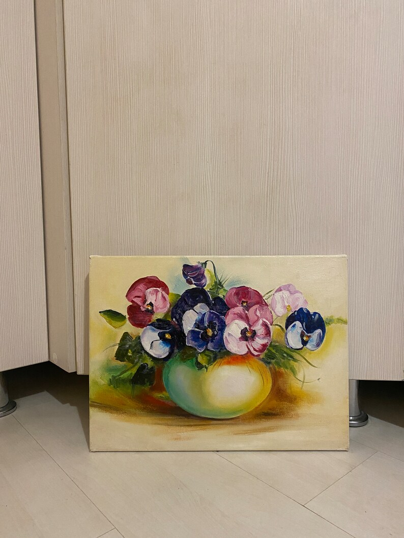 May include: A painting of a bouquet of purple, pink, and white pansies in a green vase. The pansies are arranged in a loose, natural style, and the vase is simple and elegant. The background is a soft yellow.