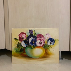 May include: A painting of a bouquet of purple, pink, and white pansies in a green vase. The pansies are arranged in a loose, natural style, and the vase is simple and elegant.