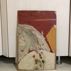 May include: Abstract painting on a wooden panel with red, yellow, white, and green paint. The painting has a geometric shape in the upper right corner and a circular shape in the lower center.