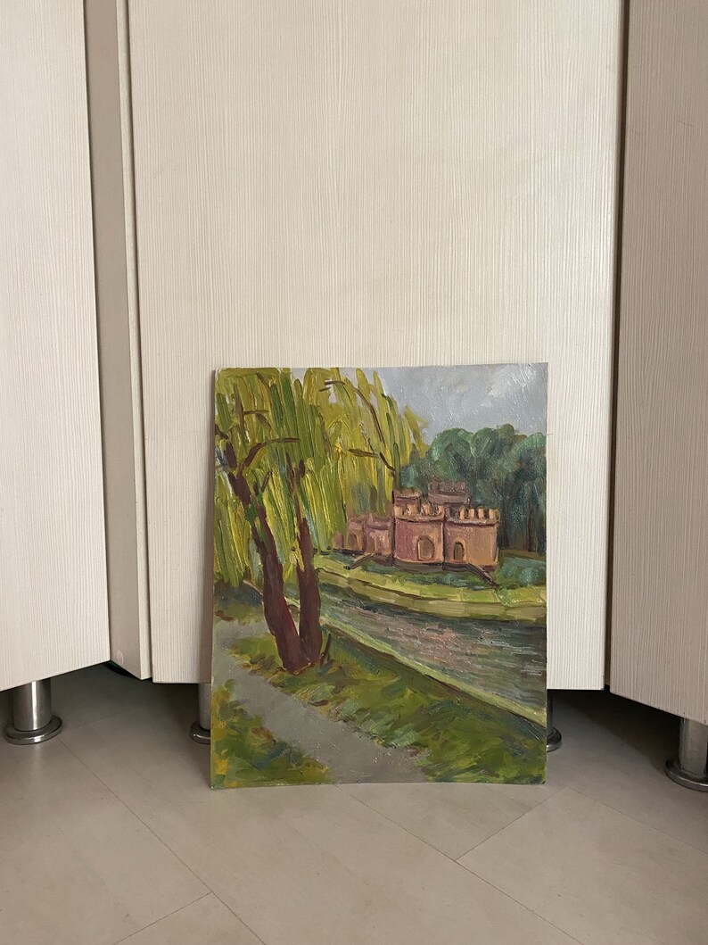 May include: A painting depicting a castle with a moat and a weeping willow tree in the foreground. The castle is painted in shades of pink and brown, and the willow tree is green. The painting is executed in a realistic style.