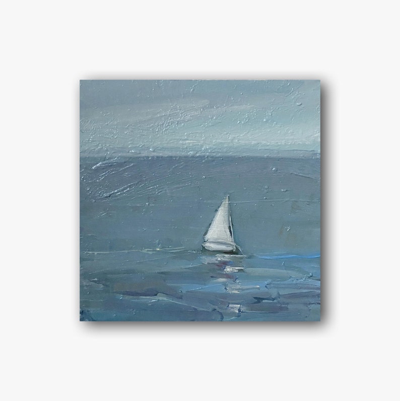 May include: A white sailboat with a single sail is sailing on a blue ocean. The sky is a light blue with some white clouds. The water is calm and the sailboat is small in the distance.