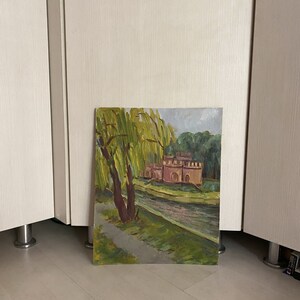 May include: A painting depicting a red brick building with a moat and a weeping willow tree in the foreground. The painting is executed in a realistic style with visible brushstrokes.