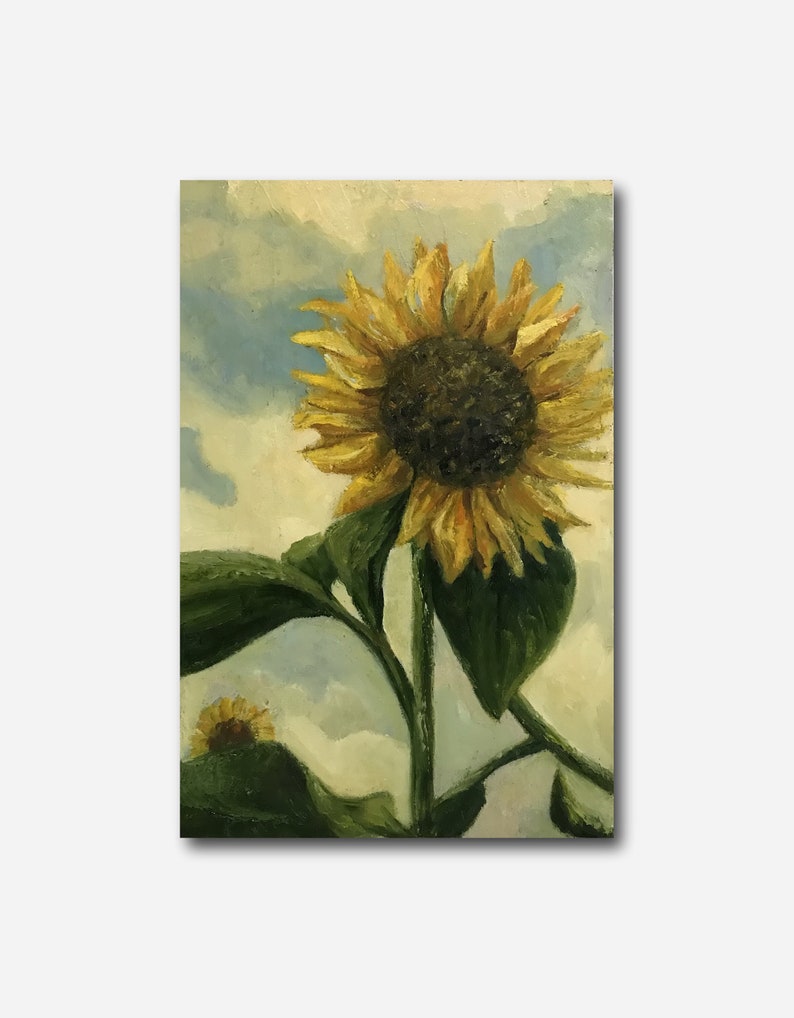 May include: A painting of a sunflower with yellow petals and a dark brown center. The sunflower is in the foreground of the painting, with a blue sky and white clouds in the background. The sunflower is tall and has green leaves.