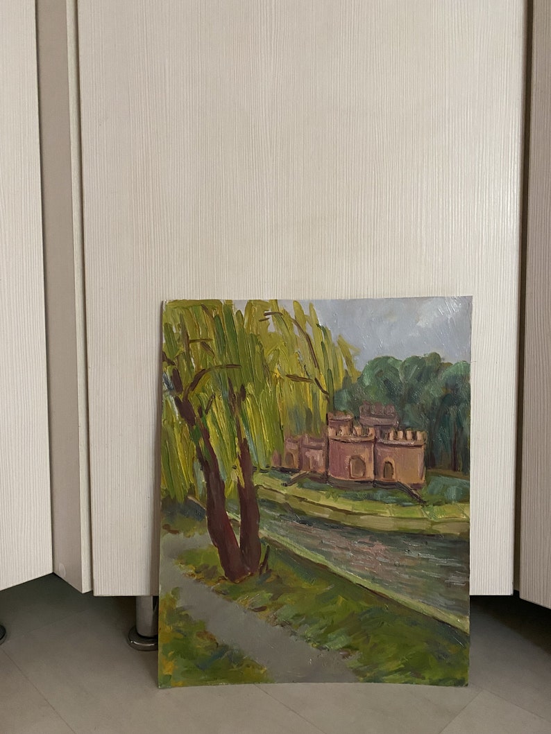 May include: A painting depicting a landscape with a river, a small castle, and a weeping willow tree. The castle is painted in shades of pink and brown, and the willow tree has green leaves. The river is a light blue colour.