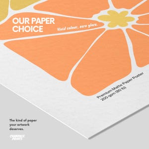 May include: A premium matte paper poster with a 200 gsm (80 lb) weight, featuring a graphic orange and yellow flower design. Text on the poster reads: OUR PAPER CHOICE, Vivid colour, zero glare, Premium Matte Paper Poster, and The kind of paper your artwork deserves. Chamonix Prints logo is visible.