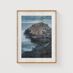 Wooden-framed print highlighting The Giants Causeways picturesque view.
